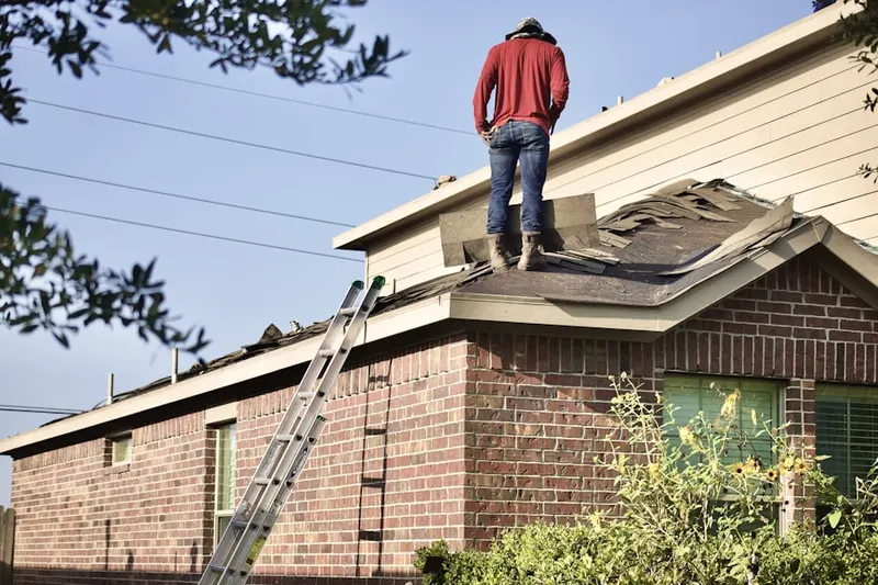 Professional roofer working on a residential roof in Oglesby